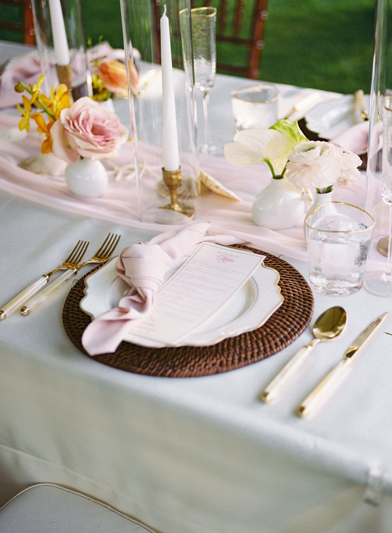 Grace gold-rim scalloped plate on a rattan charger with gold flatware and blush napkin