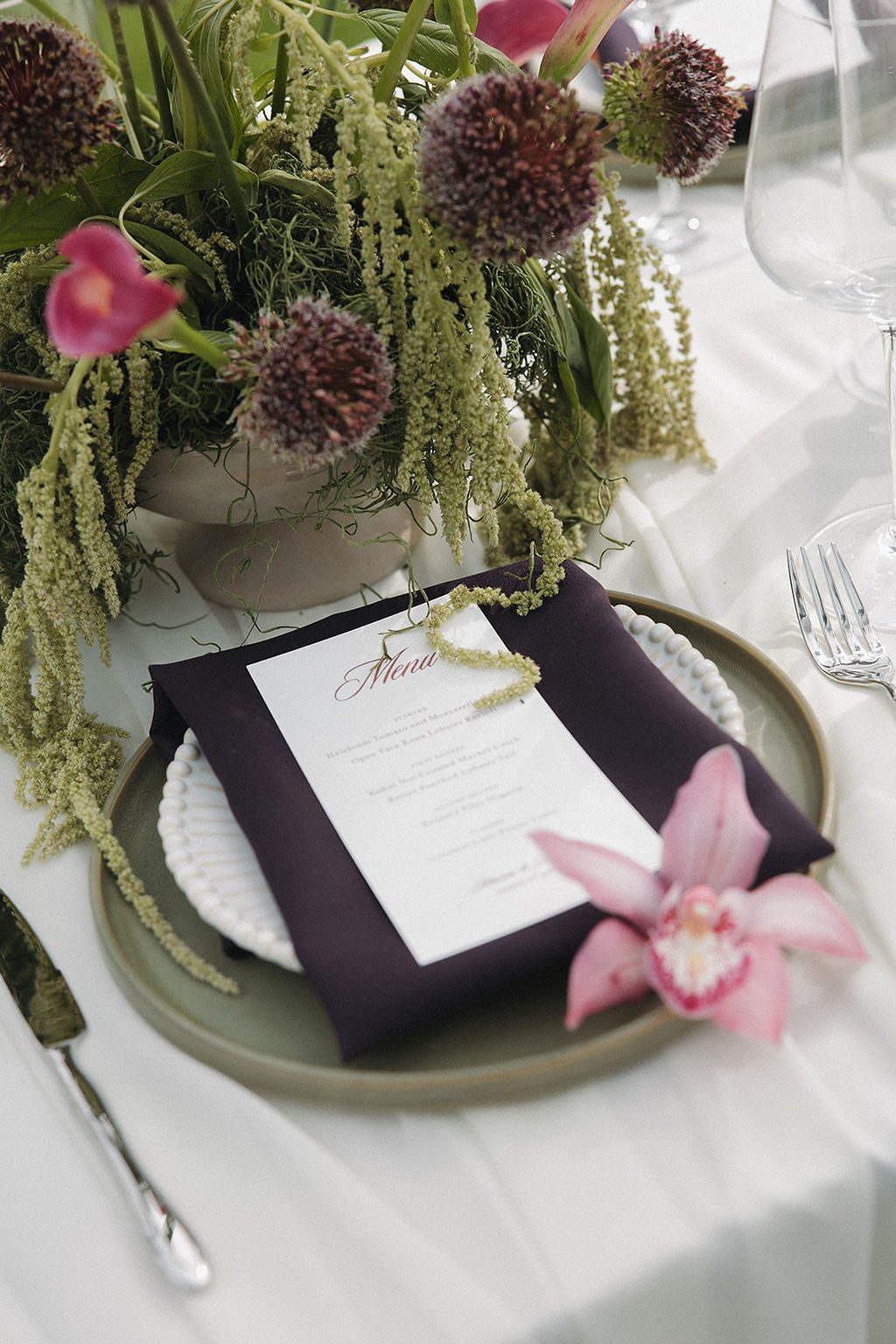 Ivy olive stoneware plate layered with a Kristine beaded plate, plum napkin and pink orchid